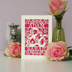 An engagement card for couple, featuring two names and a big ampersand.