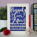 Laser cut wedding cards personalised with names and a date. Card says happily ever after in a script font