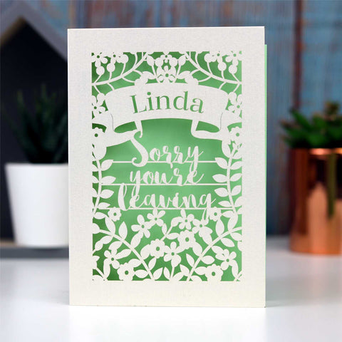 Sorry you're leaving  paper cut card with a banner so you can personalise it with the leaver's name.  Cream card with a pale green insert paper. - A5 / Light Green