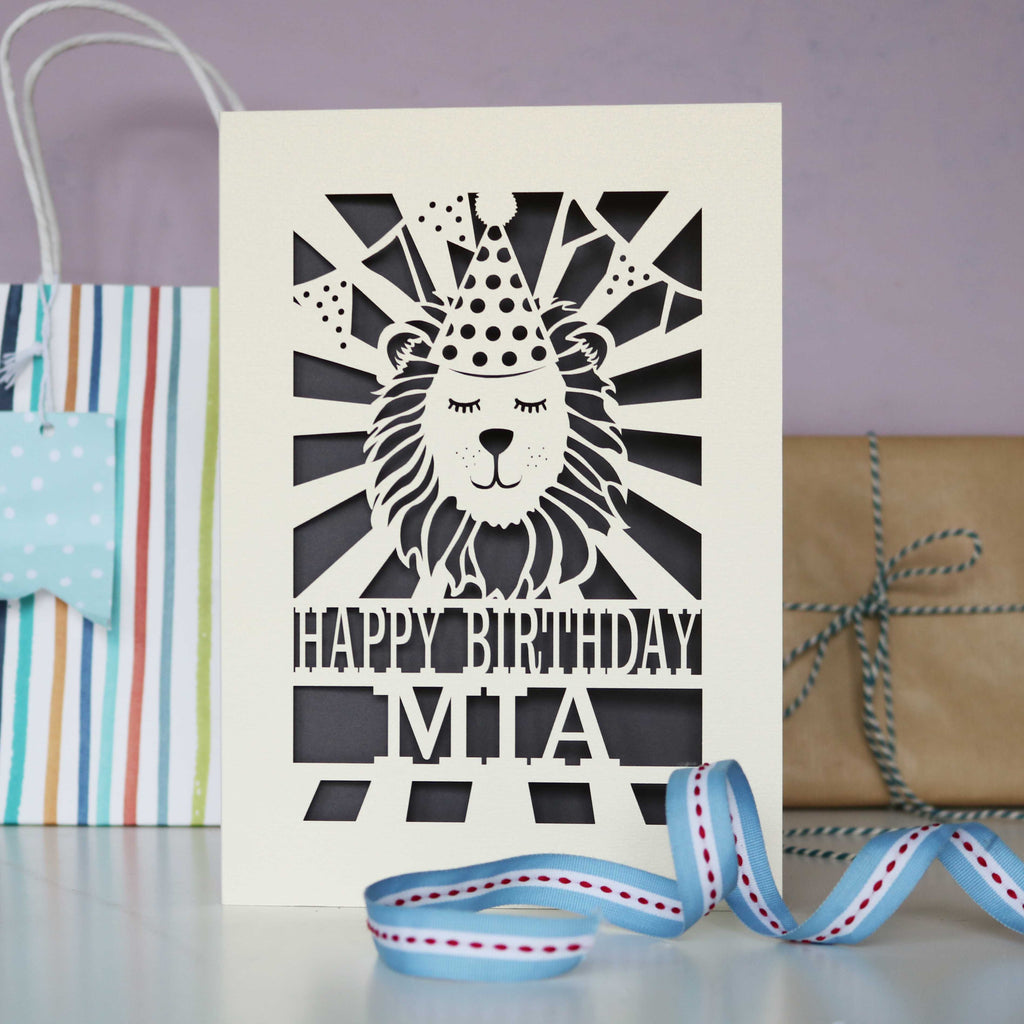 A cream and grey laser cut lion birthday card for kids