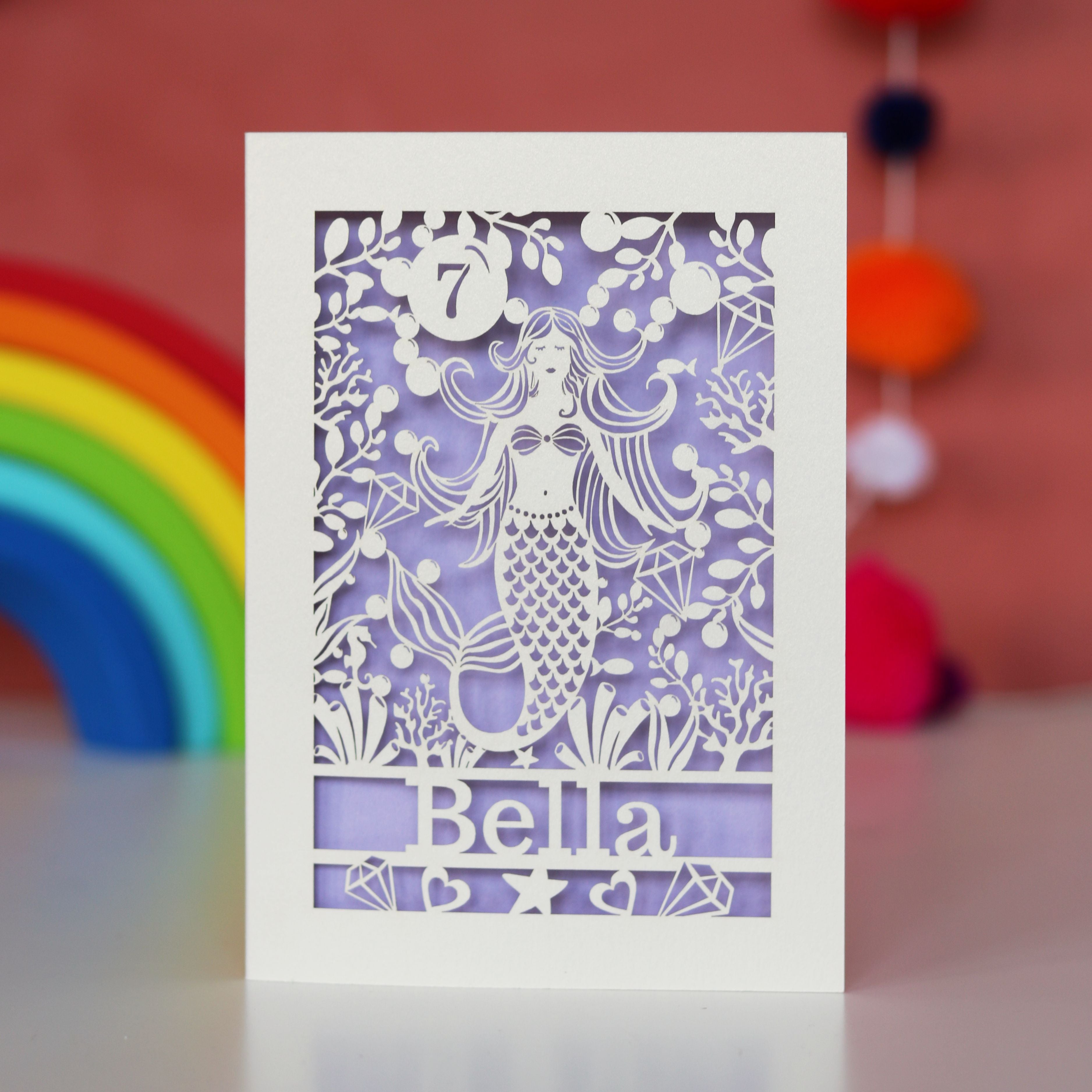 A birthday card for girls. Laser cut mermaid with a lilac background, name and age.