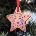 Decorative star Christmas ornament on a Christmas tree