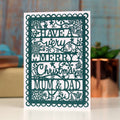 A Christmas card with a floral pattern and the text 'HAVE A VERY MERRY CHRISTMAS MUM & DAD' printed on it