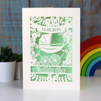 A gender neutral new baby card in cream and light green. 