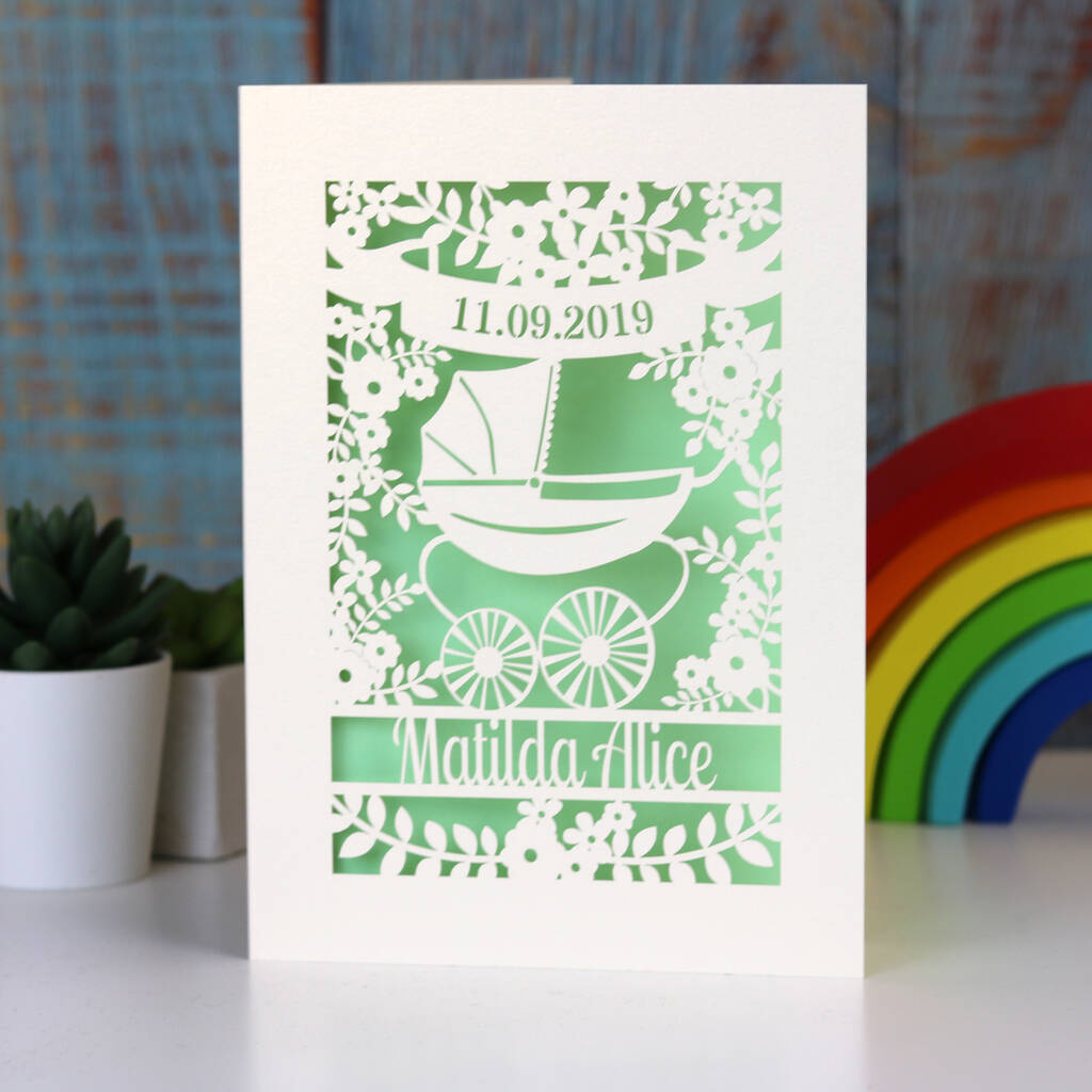 A gender neutral new baby card in cream and light green. 