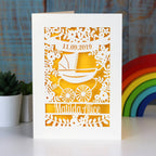 A cream and yellow gender neutral new baby card personalised with a name and date.