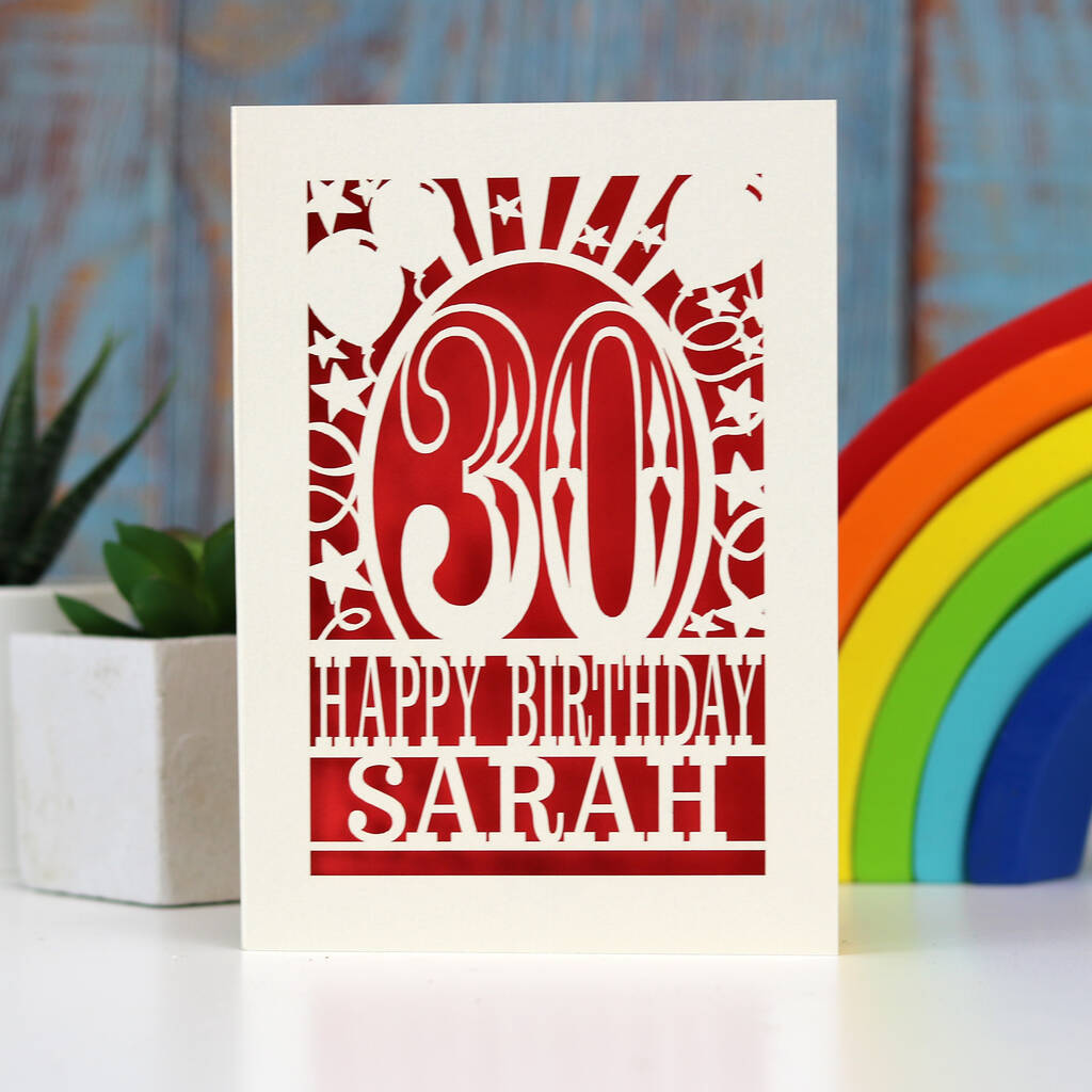 A paper cut birthday card in cream and read. Card shows a number 30, and "Happy birthday Sarah"