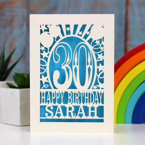 A cream and blue laser cut birthday card. Card shows 30, surrounded by stars and balloons, and reads Happy Birthday and a name. - A5 (large) / Peacock Blue