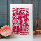 A personalised paper cut birthday card with a shocking pink paper insert. 