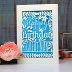 A paper cut birthday card personalised with a name.