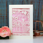 A laser cut card for birthdays. Card says Happy Birthday Great Nan, with a candy pink paper insert. 