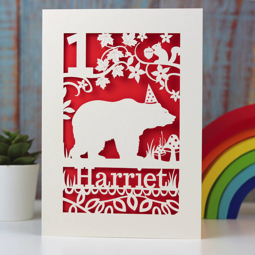 Bear in a hat under a tree with a squirrel, personalised birthday card. Laser cut from cream card with a red insert paper.