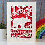 Bear in a hat under a tree with a squirrel, personalised birthday card. Laser cut from cream card with a red insert paper.