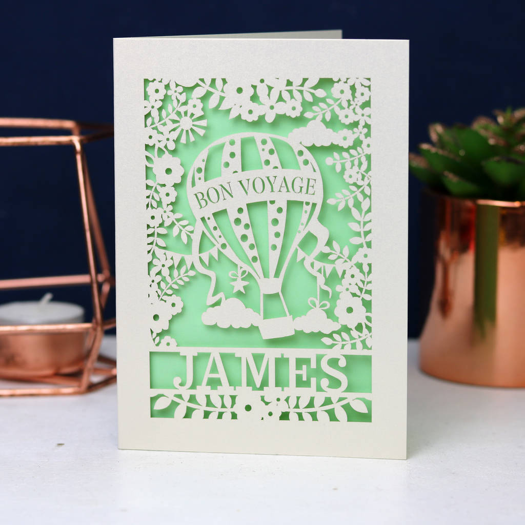 Pretty light green and cream card showing a hot air balloon flying high. Personalised with the name James across the bottom.