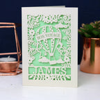 Pretty light green and cream card showing a hot air balloon flying high. Personalised with the name James across the bottom.