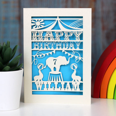 Fun circus themed personalised birthday card for child.  Cut from cream card with a bright blue background.  Personalise with a name and an age. - A6 (small) / Peacock Blue