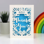 Cream card and peacock blue insert lasercut personalised Thank You card. 