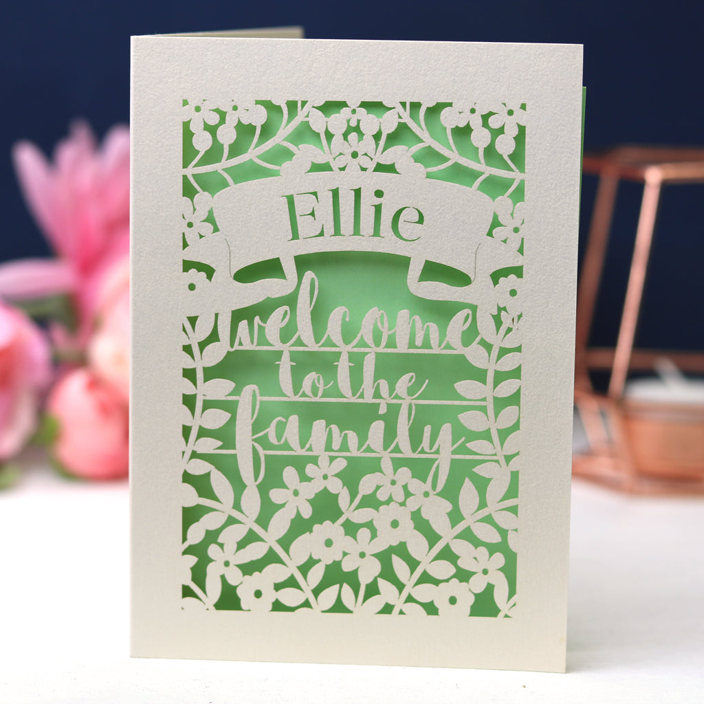 A laser cut card that says Welcome to the Family