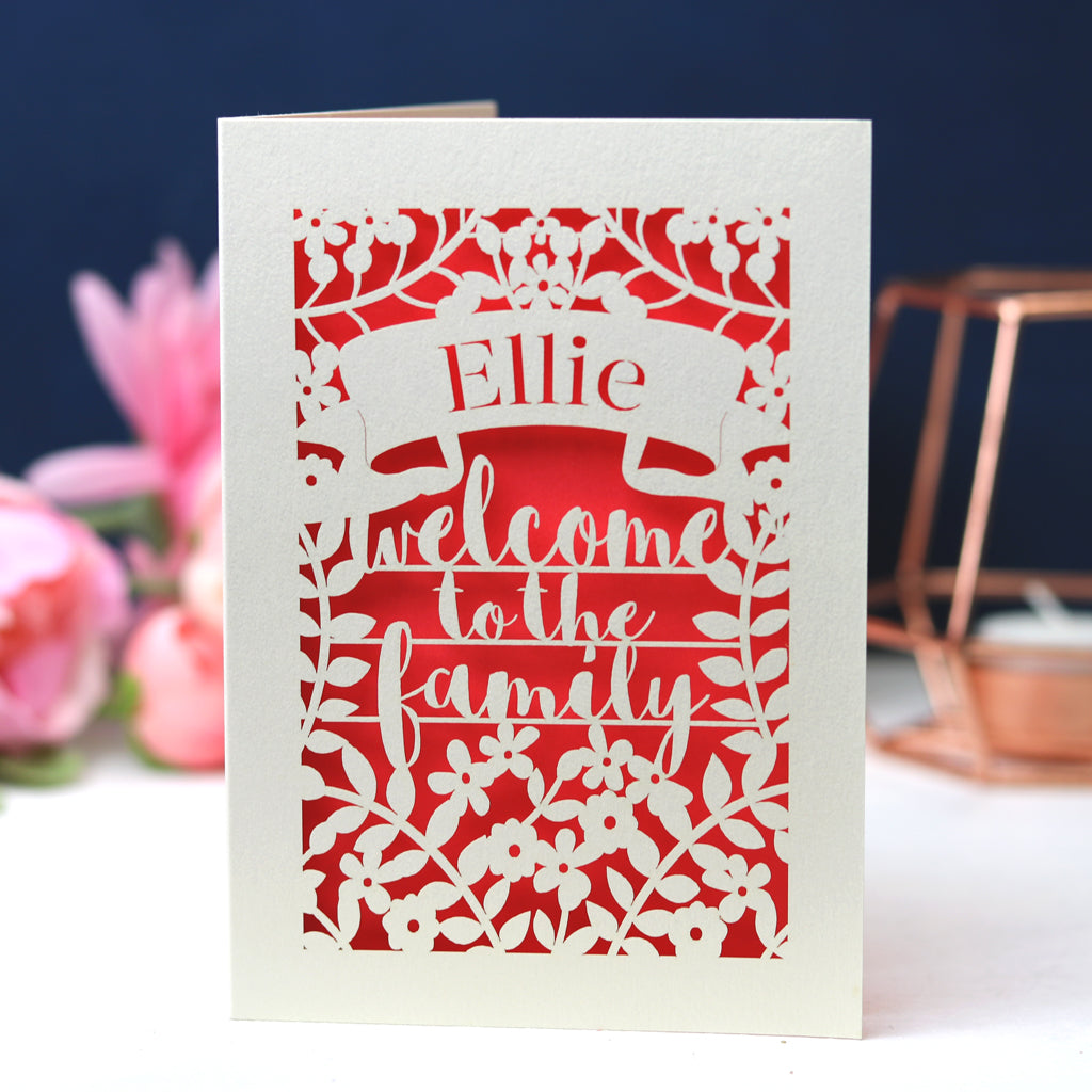 A laser cut card that says Welcome to the Family
